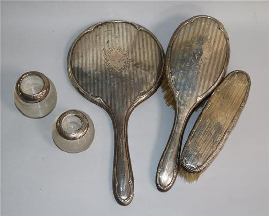 A silver dressing table part set and two match tidies.